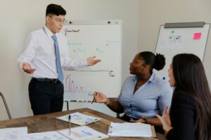 A diverse team discussing business strategies during a meeting with charts.
